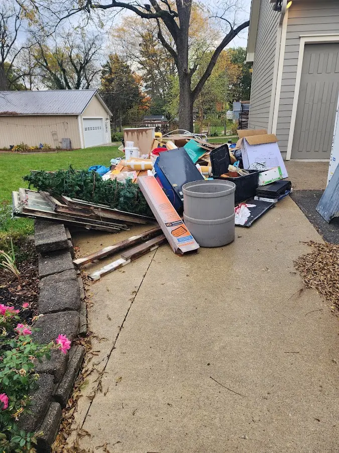 Dumpster being loaded with debris for Roofing Dumpster Rental in Caro